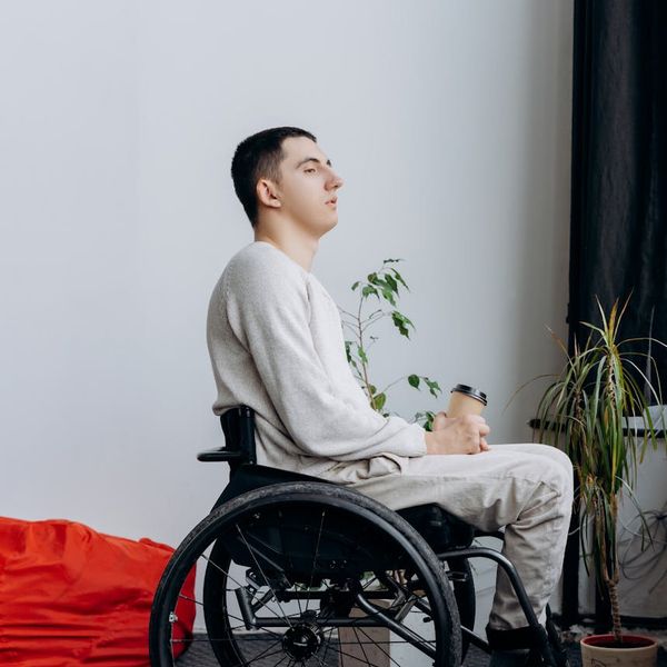 A focused man resting between sets in a modern training space.